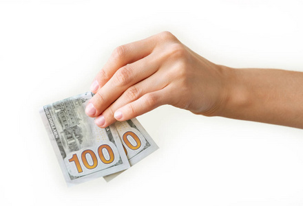 s hand is holding two hundreds of dollars, neutral background