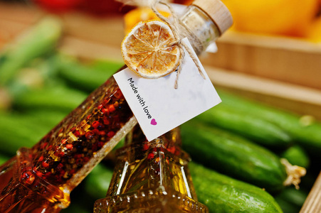 两个原始的橄榄油罐子，瓶子上有调味品，比如艾菲尔塔，架子上有黄瓜，在超市或杂货店。 用爱做的。