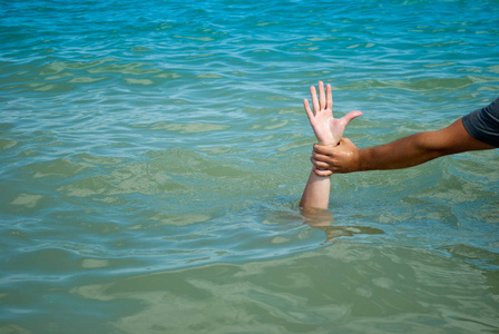 s hand drowns in water calling for help, man helps rescue, again