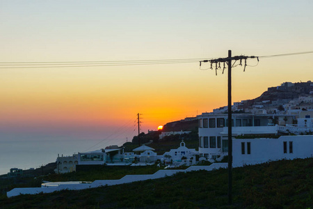 美丽的日出景观与白色建筑在桑托里尼岛希腊。