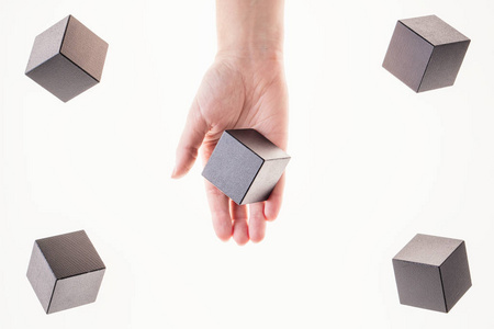 s hand takes a floating cube.  Concept of creative, logical thin