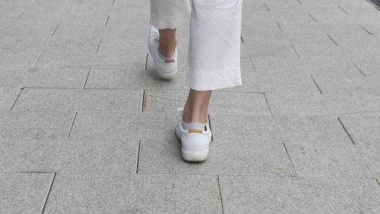 街上散步的女性腿的后视图