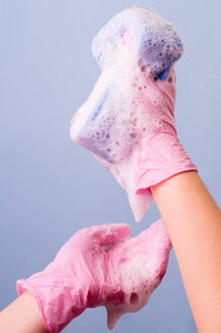 s hands wearing pink latex gloves for cleaning