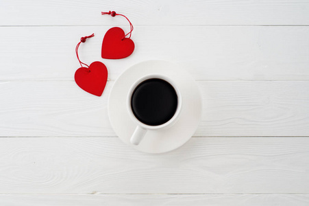 s day celebration concept with red wooden hearts and cup of coff