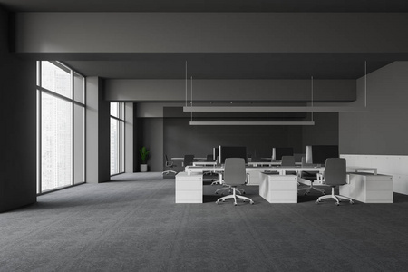 现代办公室内部有灰色的墙壁和地板开放空间区域，白色的电脑桌和灰色的椅子，会议室后面有玻璃墙。 3D渲染