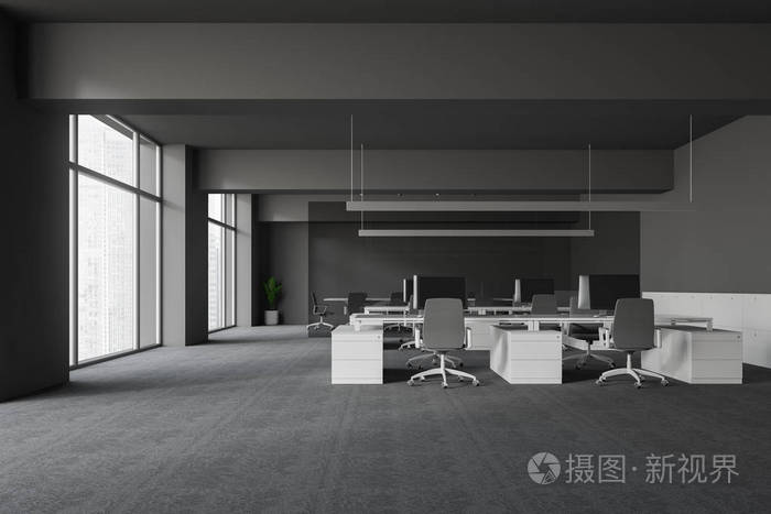 现代办公室内部有灰色的墙壁和地板开放空间区域,白色的电脑桌和灰色