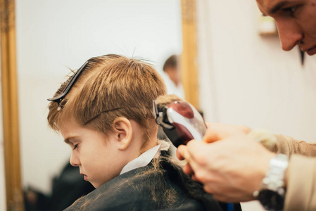 儿童剪发理发店理发小男孩剪发的剪影照片