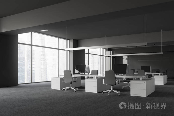 现代办公室的角落,灰色的墙壁和地板,大窗户,开放的空间区域,白色的