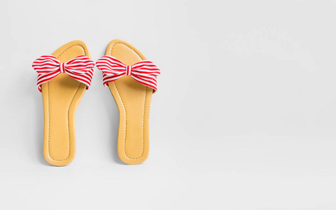 s stripy bow sandals on white background with copy space for tex