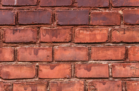 肮脏的旧红砖墙背景。肮脏的黄砖纹理。老式的墙壁背景。