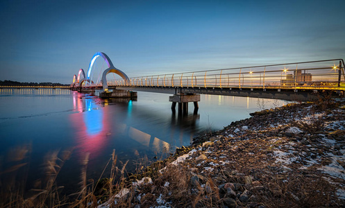 s pedestrian bridge with pink luminescence, Sweden