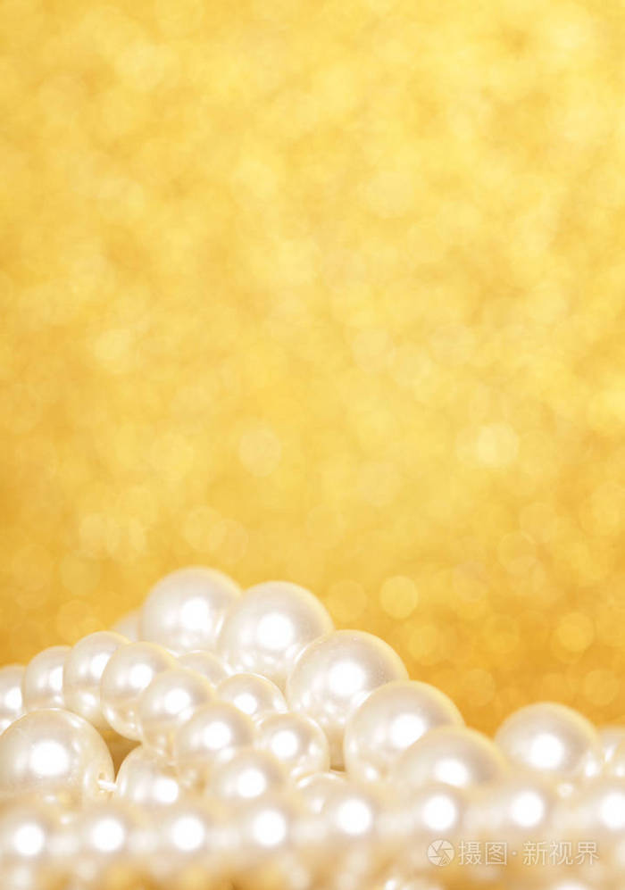 金色圣诞背景上的一堆珍珠