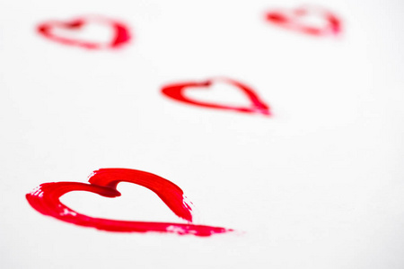 s Day. Hearts are painted in red paint on a diagonal, on white p