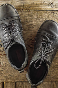 s leather moccasins on wooden background. Top view.