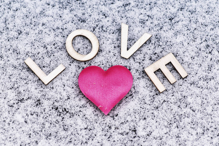 s Day. Heart of pink in the snow with the letters sweet. Valenti