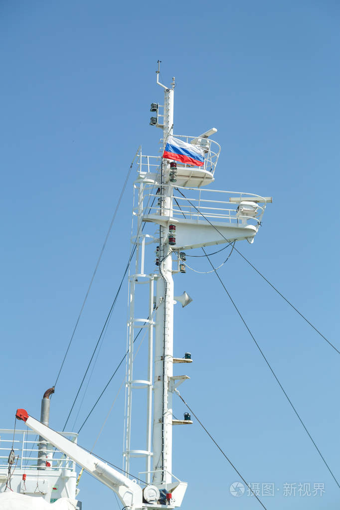 一艘带俄罗斯国旗的大型白色机动船的桅杆横向照片