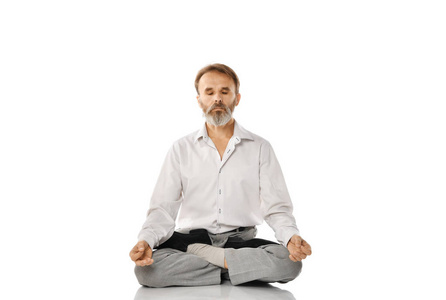 练习瑜伽经典体式的高级胡须老人在白色上的隔离姿势
