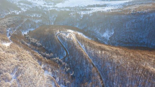 冬季道路和森林的鸟瞰图。 来自空气的自然冬季景观。 雪下的森林是冬天的时候。 无人机的景观。