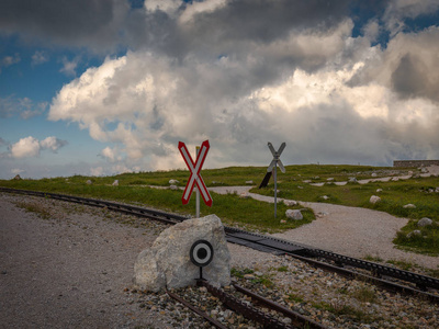 s Cross near Hochschneeberg with cloudy sky in the scenic sunset