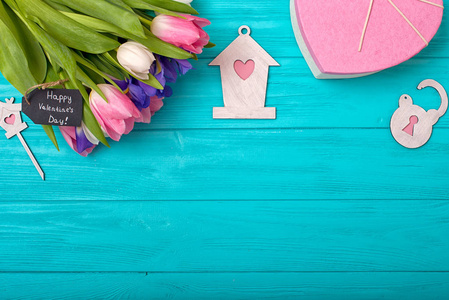 s Day background with bouquet of tulips and a gift box in the sh