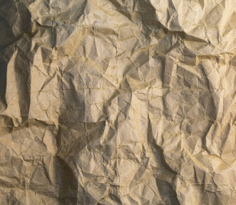 质地复古皱褶的深色纸。 皱纸的背景