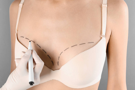 s breast for cosmetic surgery operation against gray background