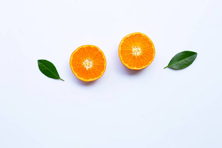 新鲜的橙色柑橘类水果，叶子在白色背景上。 顶部视图