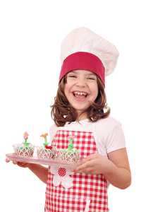 快乐的小女孩用装饰着春花的松饼做饭