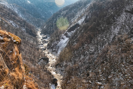 山峡的俯视图，山峡上流淌着一条山河。 在镜框里用一缕阳光射向光线