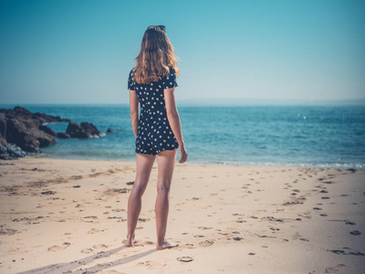 夏天，美丽的年轻女子站在海滩上