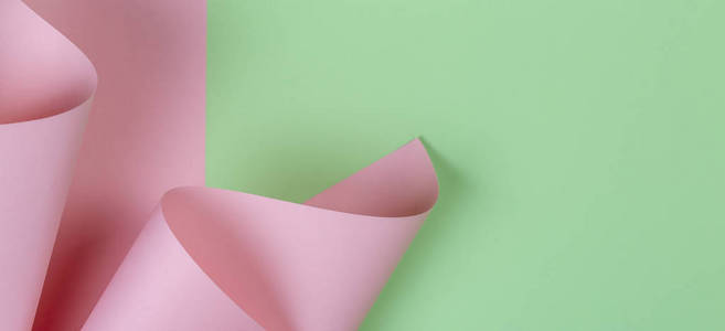 抽象几何形状柔和的粉红色和绿色的纸背景