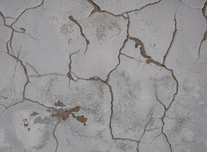 混凝土上有裂缝和划痕的旧破损石膏的质地和背景。