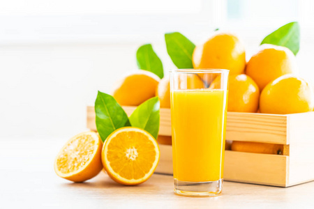 木桌玻璃中的新鲜橙汁健康食品概念