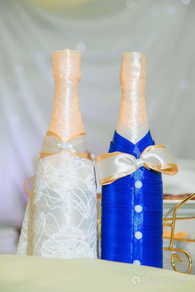 新婚夫妇的婚礼桌子。 新娘和新郎的瓶子。 餐桌装饰。 婚礼。 结婚瓶的登记。 香槟。