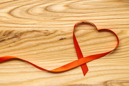 s Day. Heartshaped ribbons on a wooden table. Top view. Copy sp