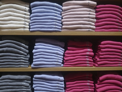 s multicolored knitted shirts on store shelves Closeup