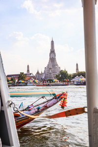泰国河畔交通在潮法拉河与瓦阿伦佛寺黎明背景曼谷。 传统泰国旅游景点亚洲文化旅游河流邮轮概念