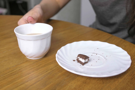 女人正在吃一块巧克力蛋糕, 喝咖啡。特写镜头