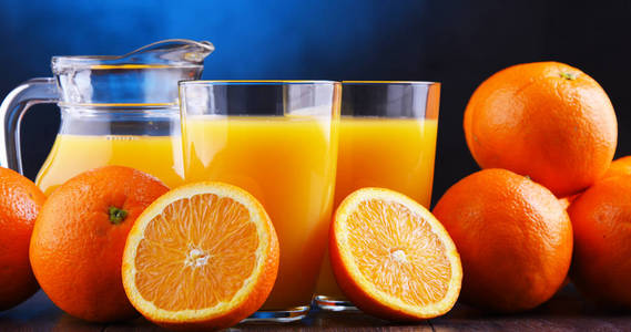 带新鲜橙汁和水果的玻璃杯