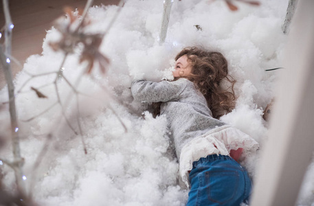 s room. The girl plays with artificial snow