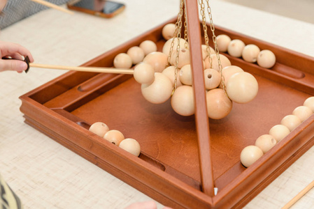 s game with wooden balls. Children play a game with balls. Educa