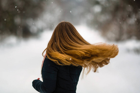s long hair. Fluttering beautiful hair of young woman in winter 