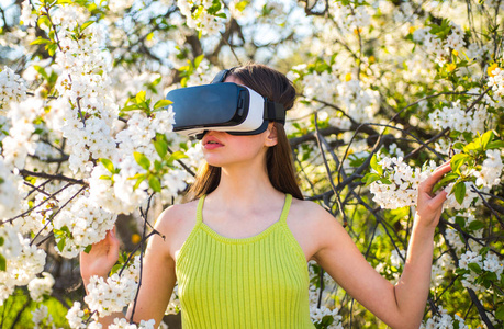获取3d 图像。创新的 vr 技术。漂亮的女孩在虚拟现实耳机。可爱的女孩在春天的花园玩。年轻的女士戴春天的大自然。虚拟技术仿真