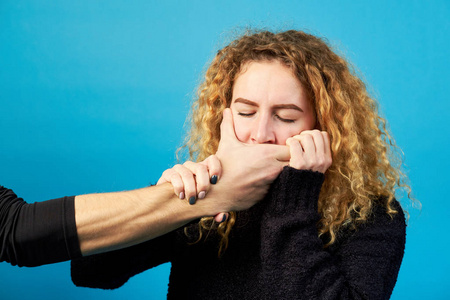 s hand covering the mouth of a young redhead attractive girl or 