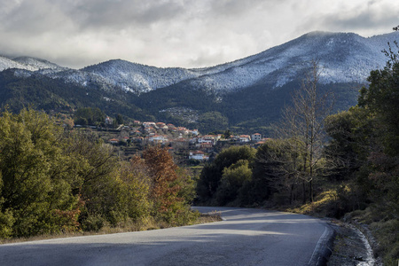 在一个多山的乡村里的Dyrrachi村和阳光明媚的冬日的道路奔尼撒希腊山脉塔耶格图斯。