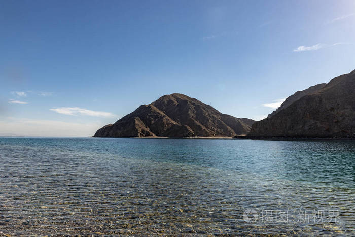 在阳光下看海边的山