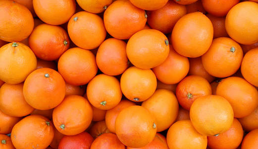 刚从果园树上摘下来的多汁成熟橘子的背景