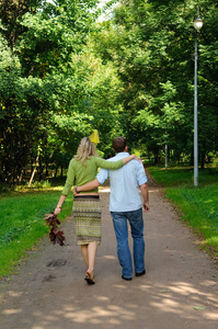 一对年轻夫妇在公园里拥抱。