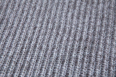 针织无缝图案。 灰色羊毛背景。 旧的手工编织。