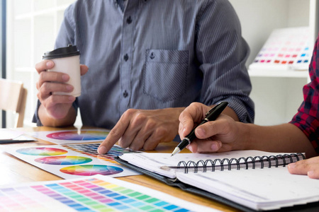 平面设计师从彩色带样本中选择颜色进行设计。设计师图形创意工作理念。